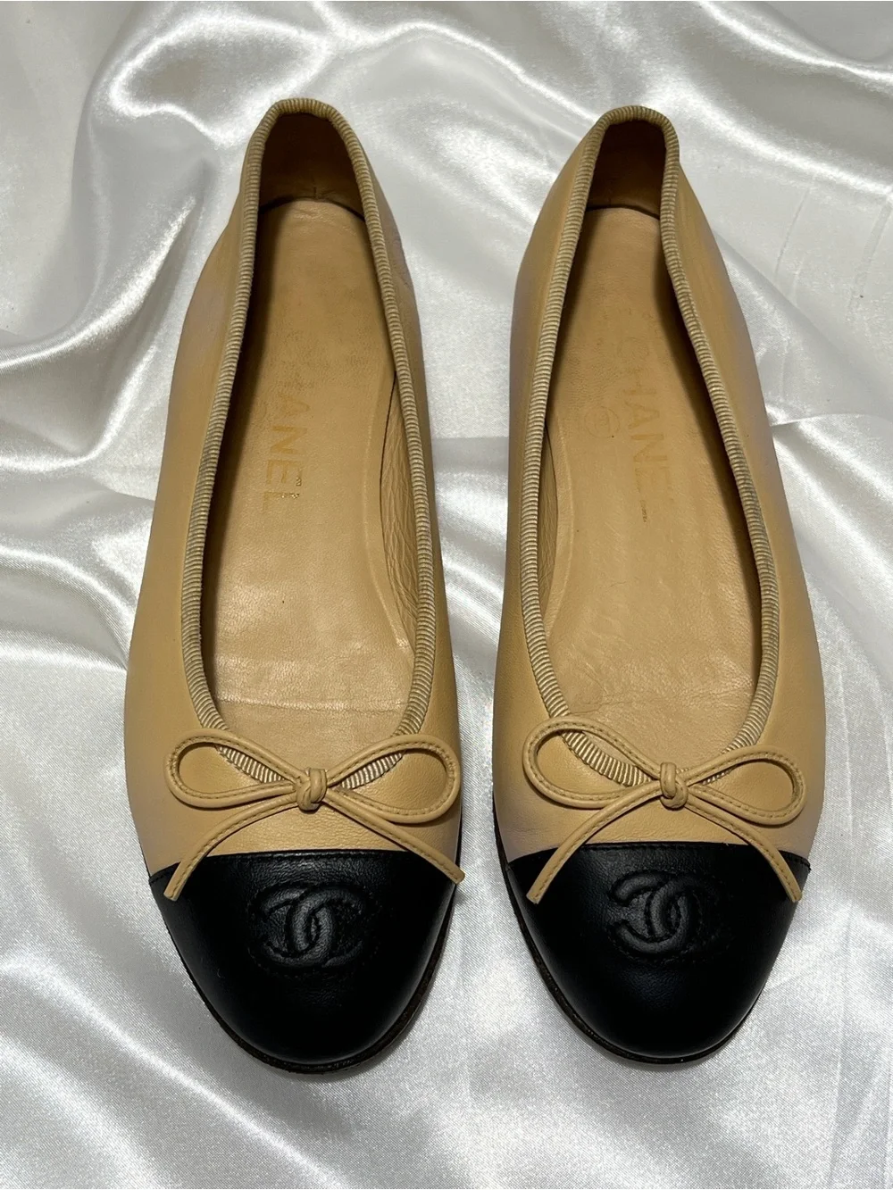 CHANEL Beige Leather Ballet Flats with Black Cap Toe and CC Logo
